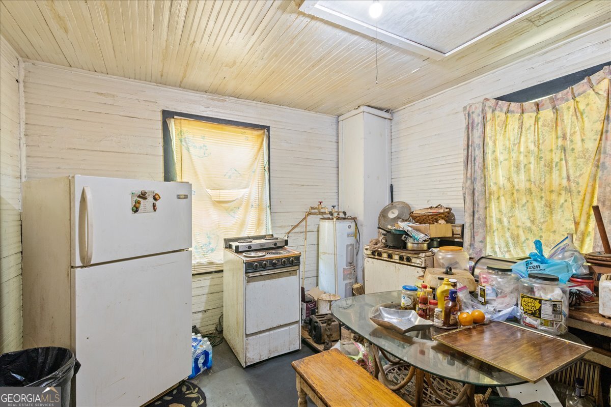 1367 Wrightsboro Road Augusta, GA 30901 - Photo 22 of 49 a kitchen with sink refrigerator and stove