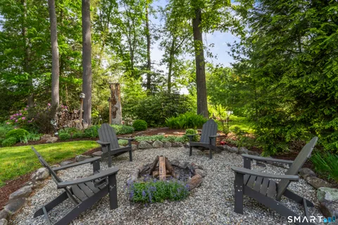 a backyard of a house with table and chairs