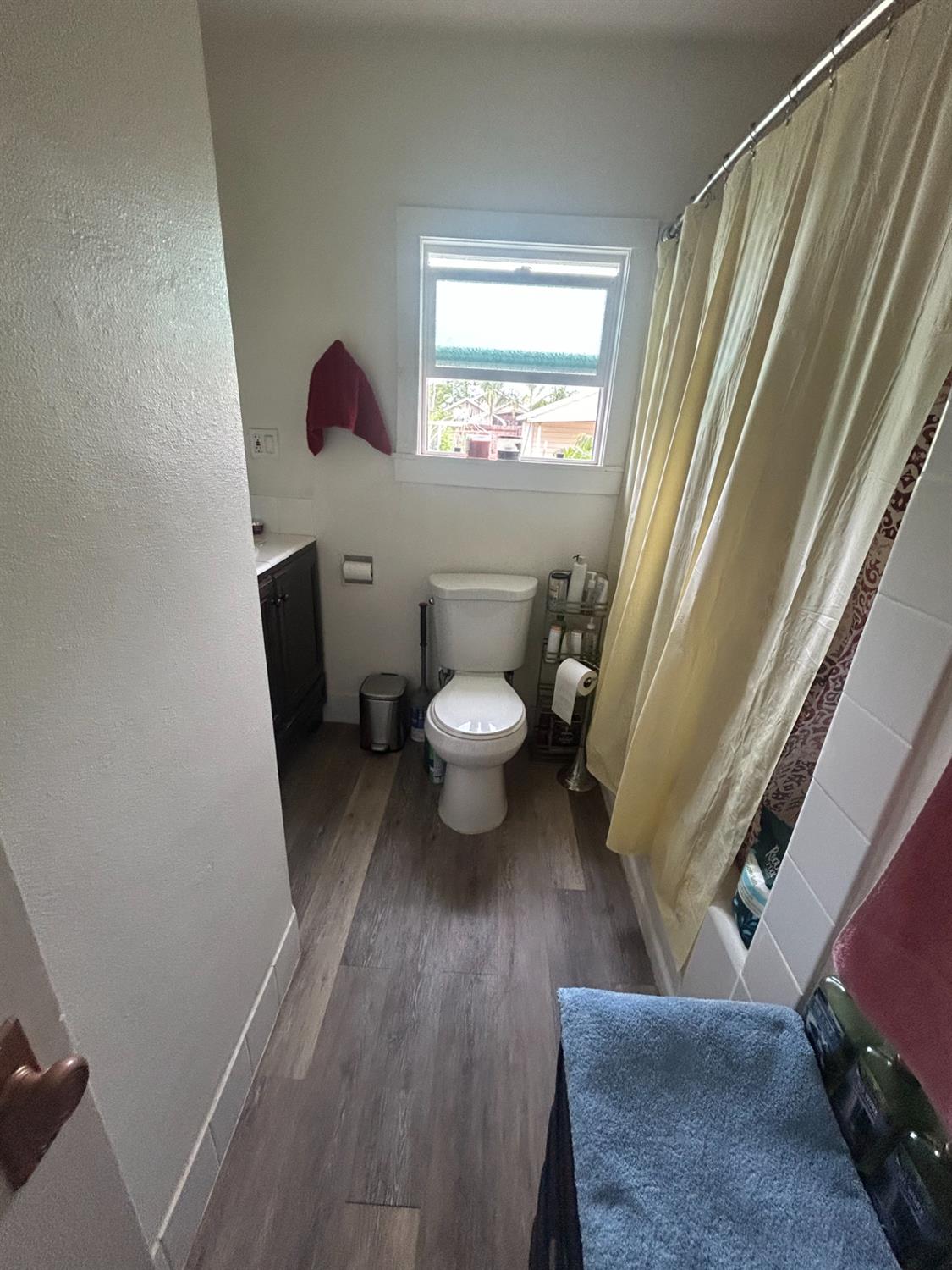 313 East Sacramento Street Coalinga, CA 93210 - Photo 11 of 23 a view of a hallway with wooden floor and a toilet