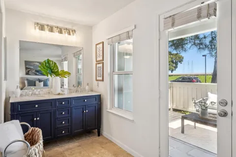 a spacious bathroom with a granite countertop sink and a mirror