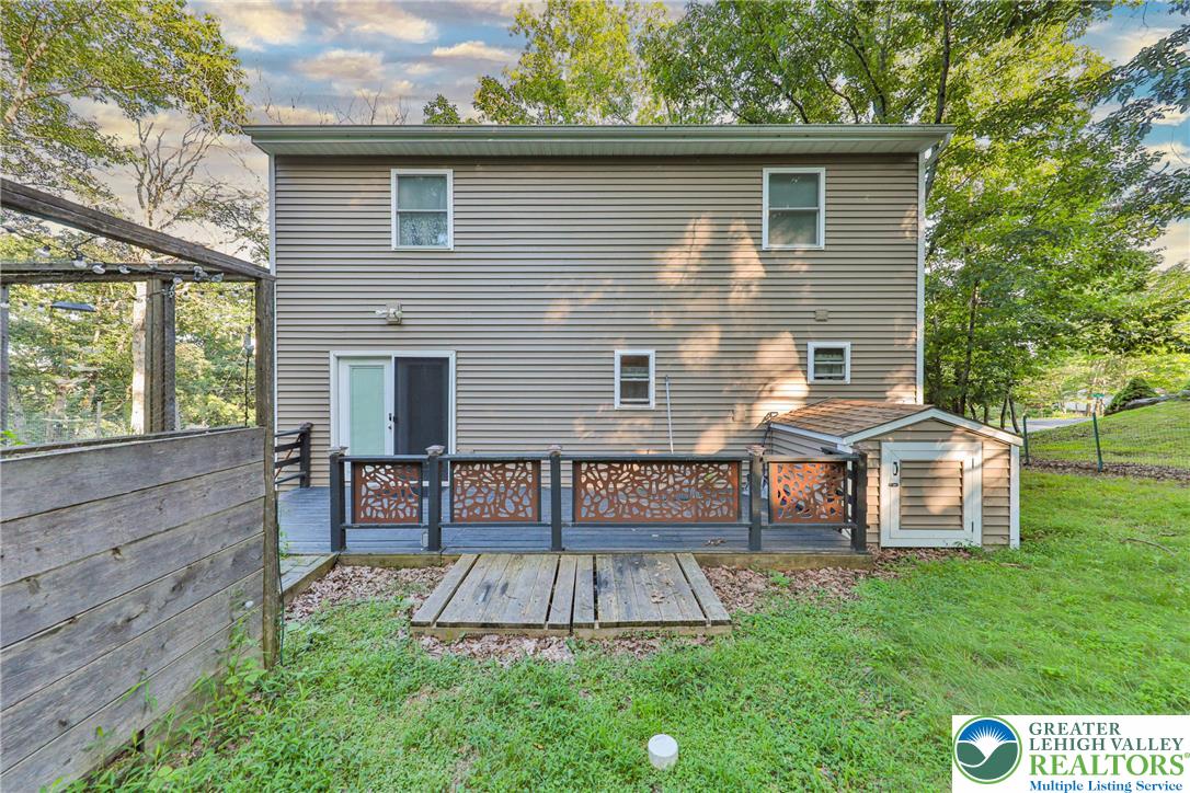 2114 Lakeview Road Bushkill, PA 18324 - Photo 59 of 83 An elevated wood deck spans the rear exterior facade alongside a storage shed.