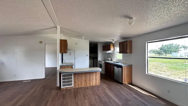 a kitchen with stainless steel appliances granite countertop a stove and refrigerator