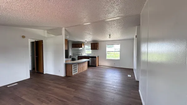 a view of kitchen with wooden floor and electronic appliances