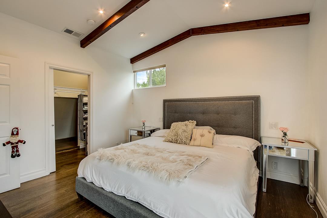 776 Lockhaven Drive Pacifica, CA 94044 - Photo 24 of 49 a bedroom with a bed and wooden floor