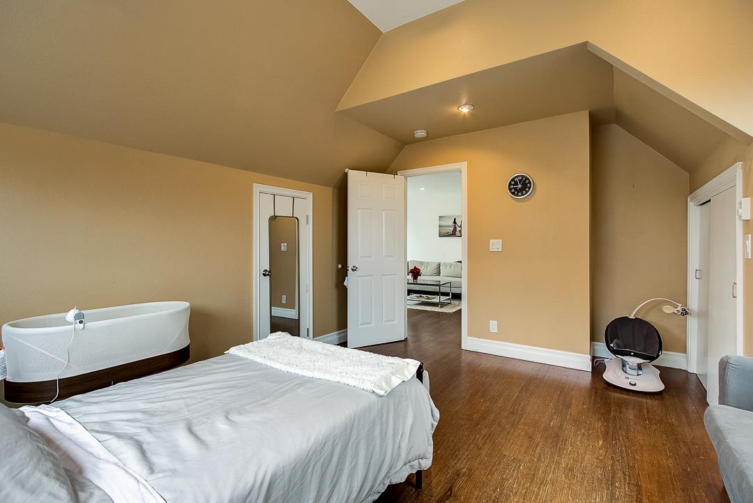 776 Lockhaven Drive Pacifica, CA 94044 - Photo 31 of 49 a bedroom with bed and wooden floor