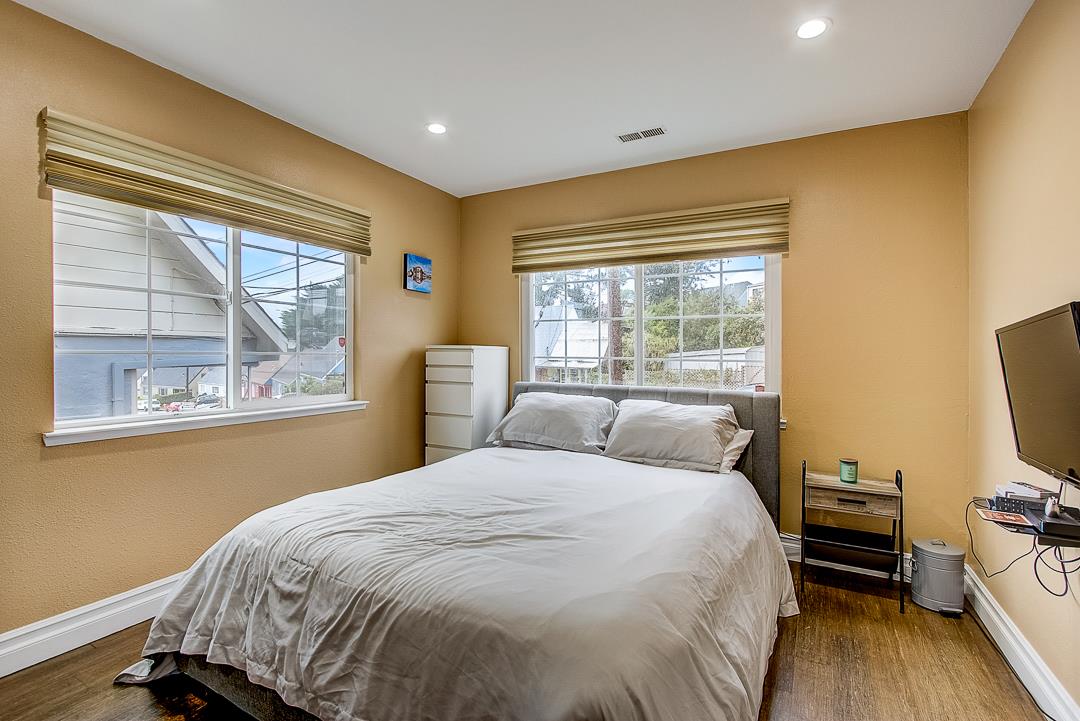 776 Lockhaven Drive Pacifica, CA 94044 - Photo 32 of 49 a bedroom with a bed and wooden floor