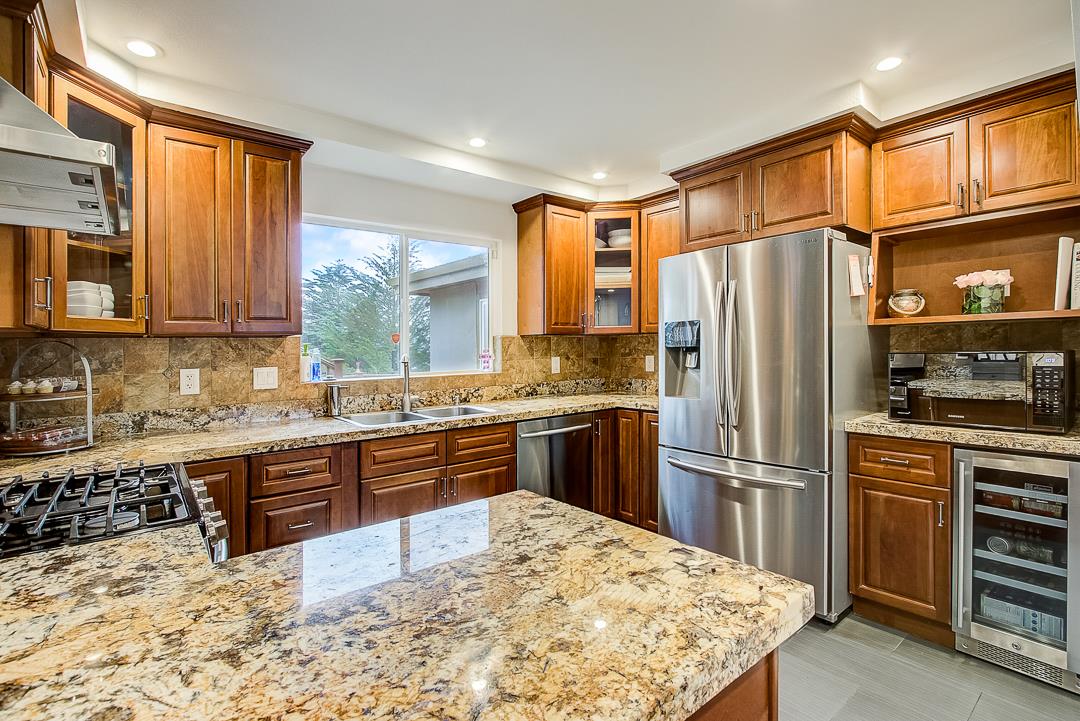 776 Lockhaven Drive Pacifica, CA 94044 - Photo 9 of 49 a kitchen with stainless steel appliances kitchen island granite countertop a refrigerator stove top oven and sink