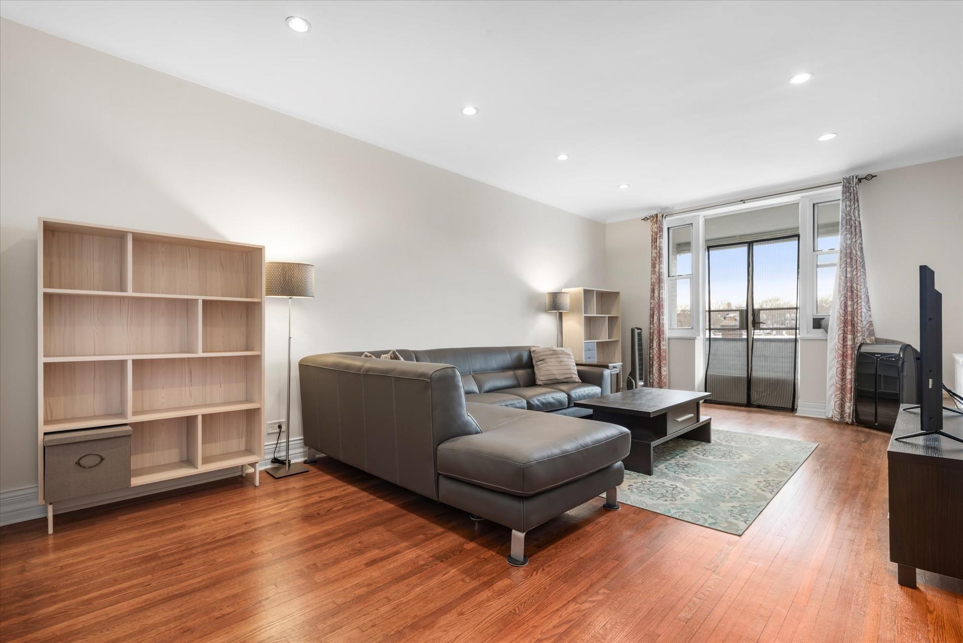 34-41 85th Street, Unit 4H Queens, NY 11372 - Photo 2 of 23 Living room featuring recessed lighting, baseboards, and hardwood / wood-style floors