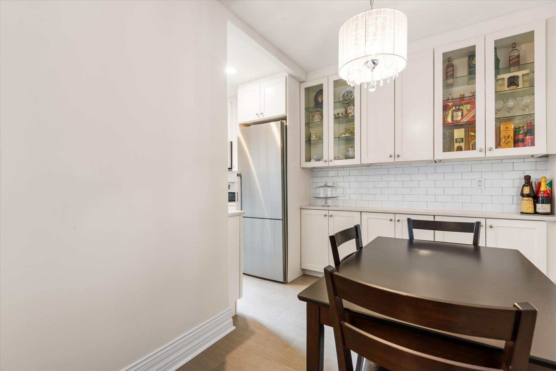 34-41 85th Street, Unit 4H Queens, NY 11372 - Photo 7 of 23 Dining space featuring baseboards and a notable chandelier