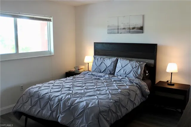 a bedroom with a bed and window