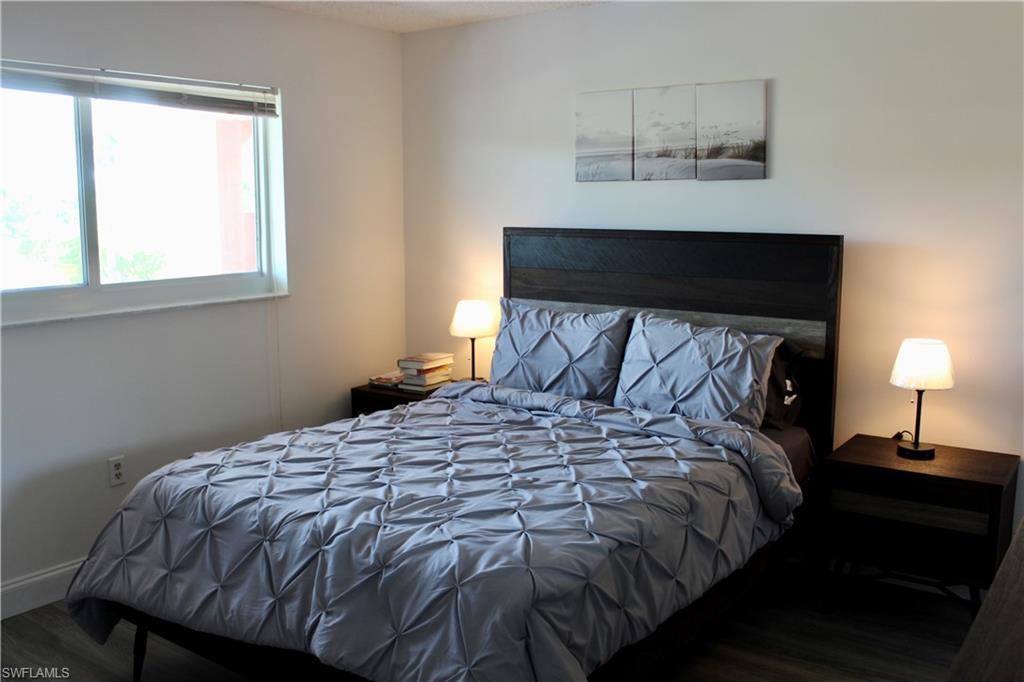 400 Forest Lakes Boulevard, Unit 309 Naples, FL 34105 - Photo 9 of 12 a bedroom with a bed and window