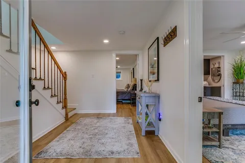 a view of a hallway view with wooden floor and staircase