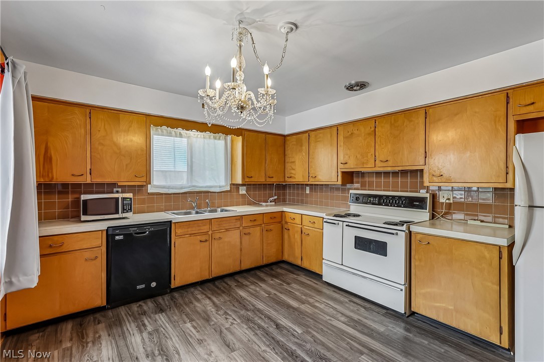2060 6th Street Southwest Akron, OH 44314 - Photo 13 of 46 Eat-in kitchen features chandelier, sink, cabinets, dishwasher, stove, refigerator and plenty of counter space