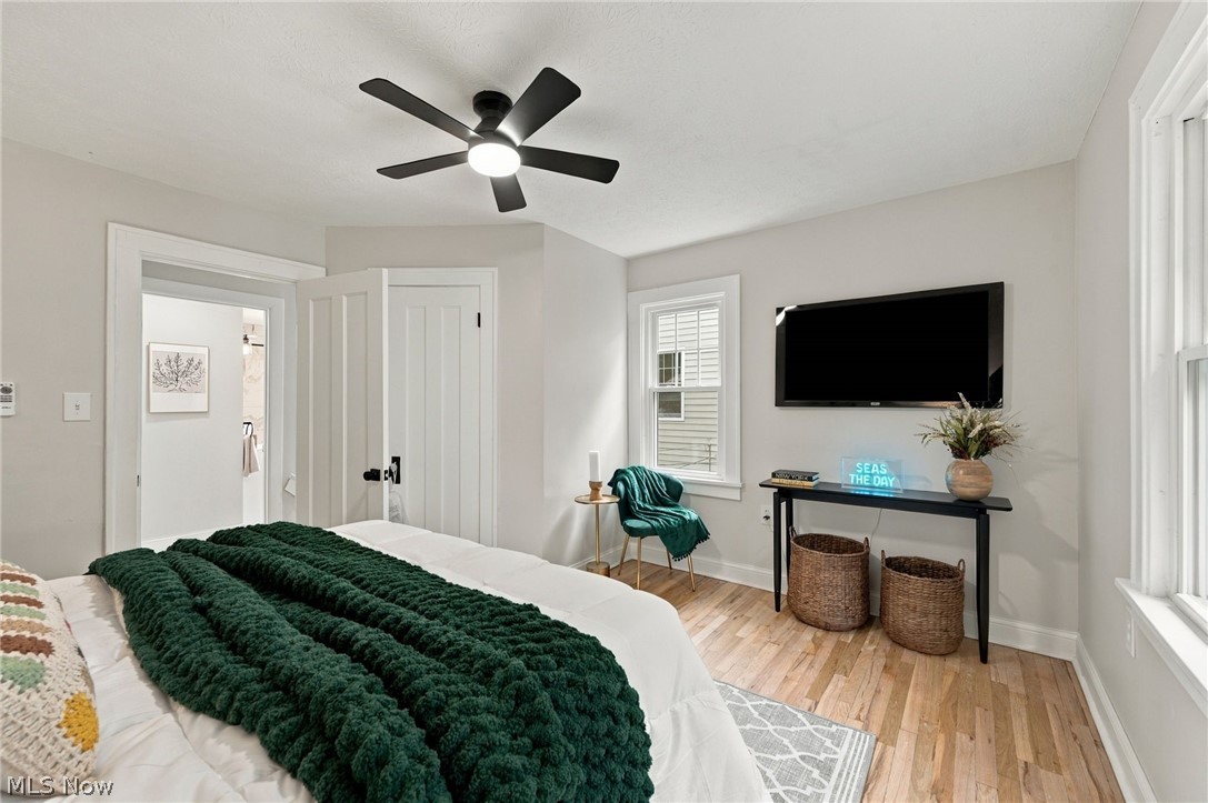1173 Yellowstone Road Cleveland Heights, OH 44121 - Photo 22 of 44 Light-toned wood-finish flooring, a contemporary ceiling fan with integrated lighting, and multiple windows