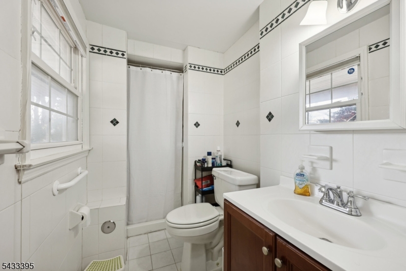 48 Woodmont Road Montclair, NJ 07043 - Photo 13 of 20 a bathroom with a sink a toilet and shower