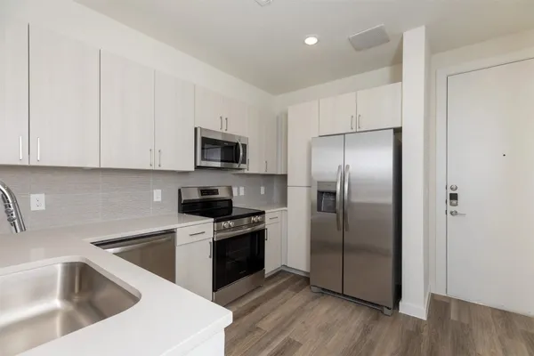 a kitchen with a refrigerator sink and microwave