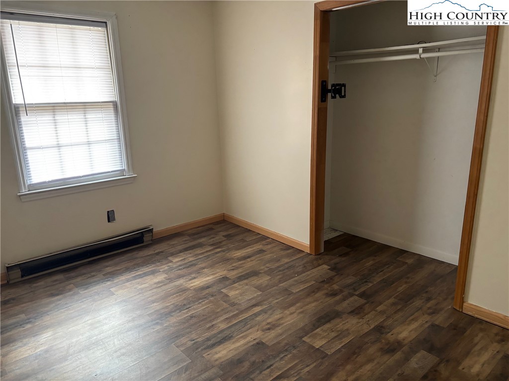 88 Grandridge Road Sparta, NC 28675 - Photo 11 of 21 a view of an empty room with wooden floor and a window