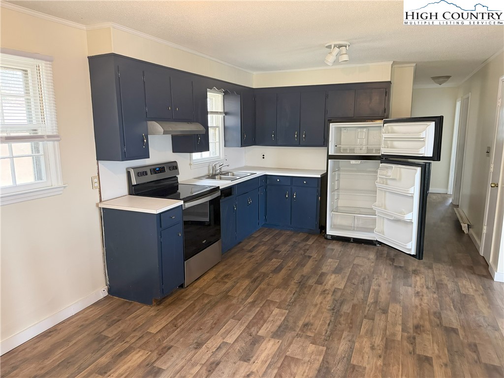 88 Grandridge Road Sparta, NC 28675 - Photo 2 of 21 a kitchen with wooden cabinets and a sink