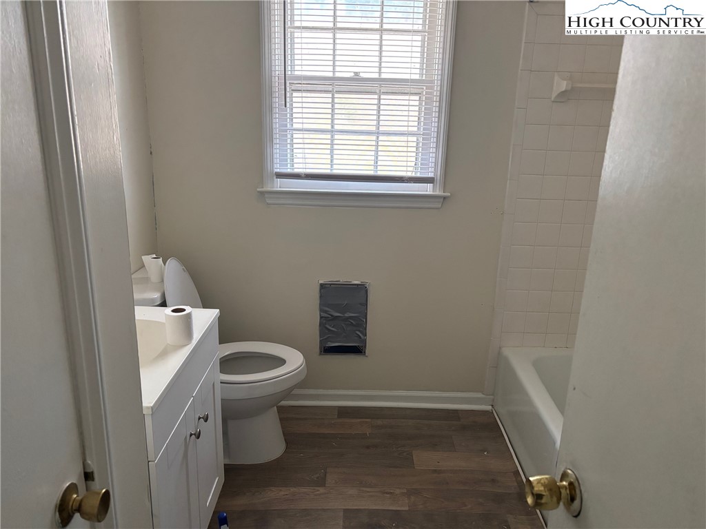 88 Grandridge Road Sparta, NC 28675 - Photo 8 of 21 a white toilet sitting in a bathroom next to a window