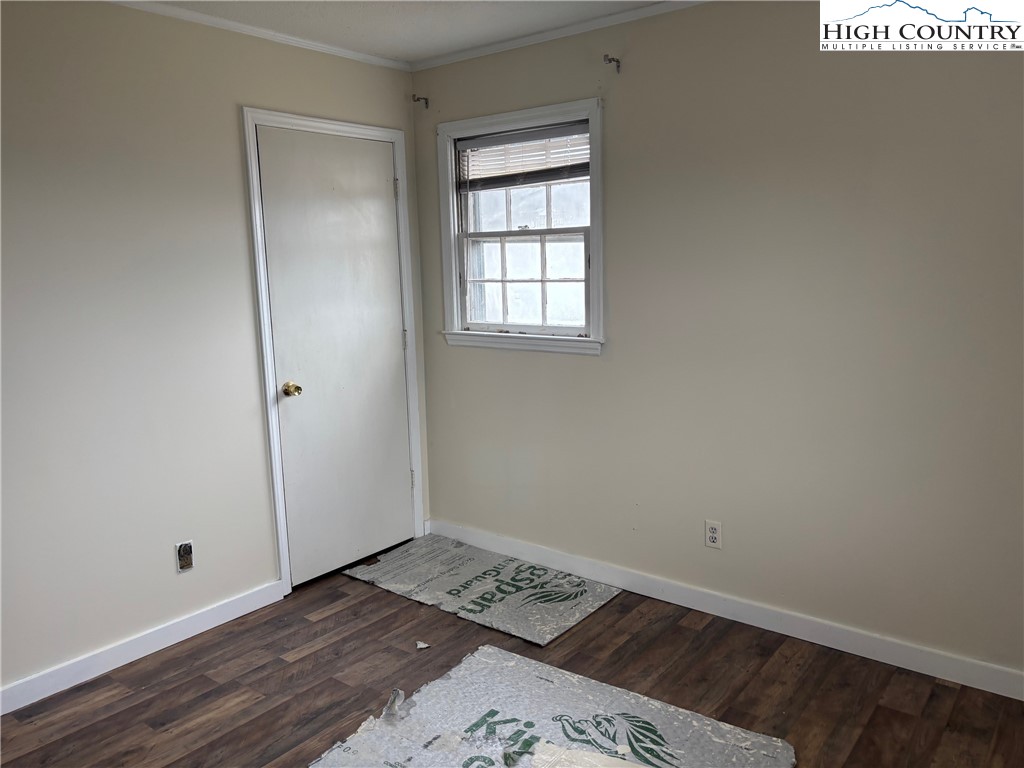 88 Grandridge Road Sparta, NC 28675 - Photo 9 of 21 a view of an empty room with wooden floor and a window