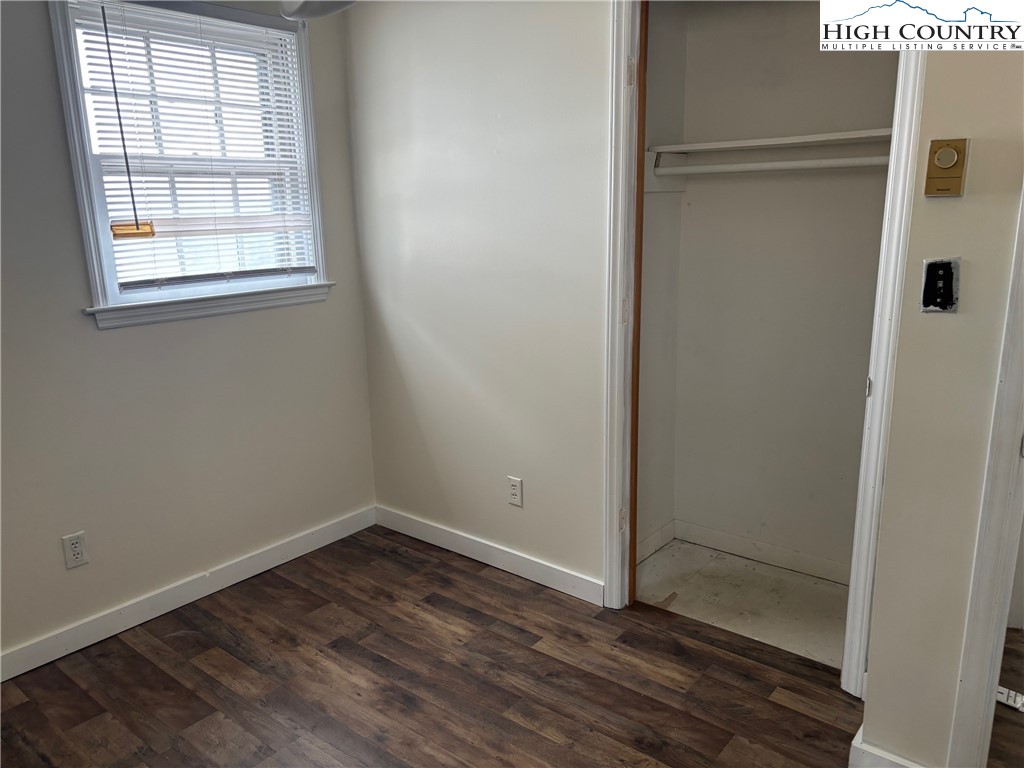 88 Grandridge Road Sparta, NC 28675 - Photo 10 of 21 an empty room with wooden floor and windows