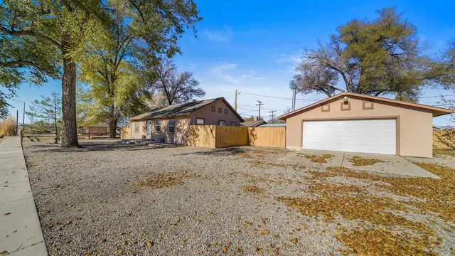 a view of a house with a yard and garage