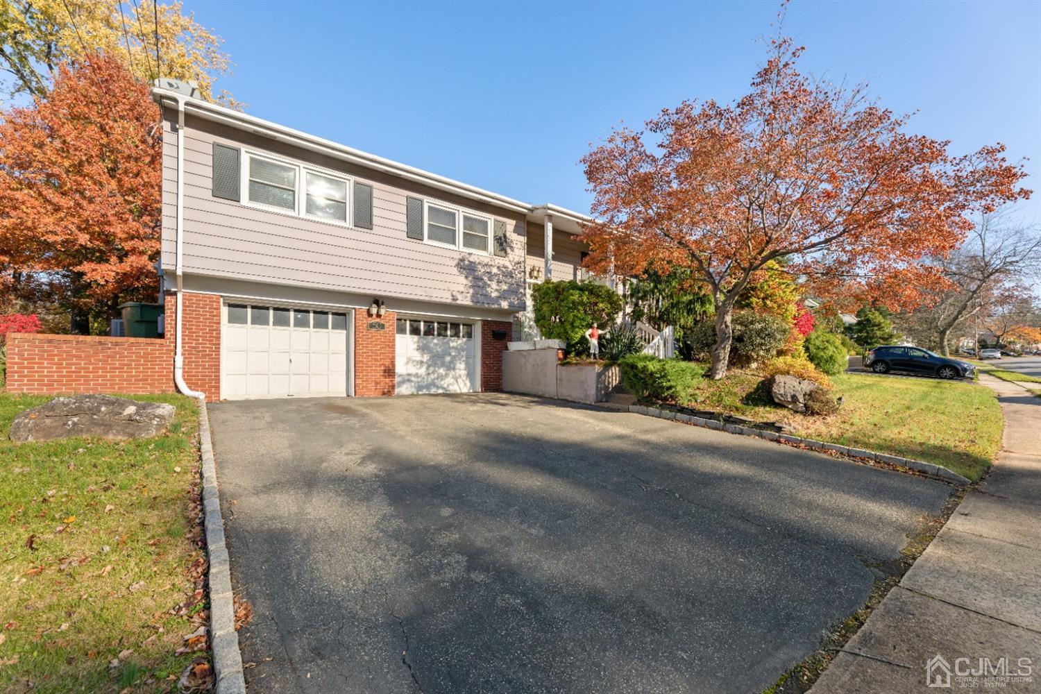 50 Wilk Road Edison, NJ 08837 - Photo 1 of 27 a front view of a house with a yard and garage
