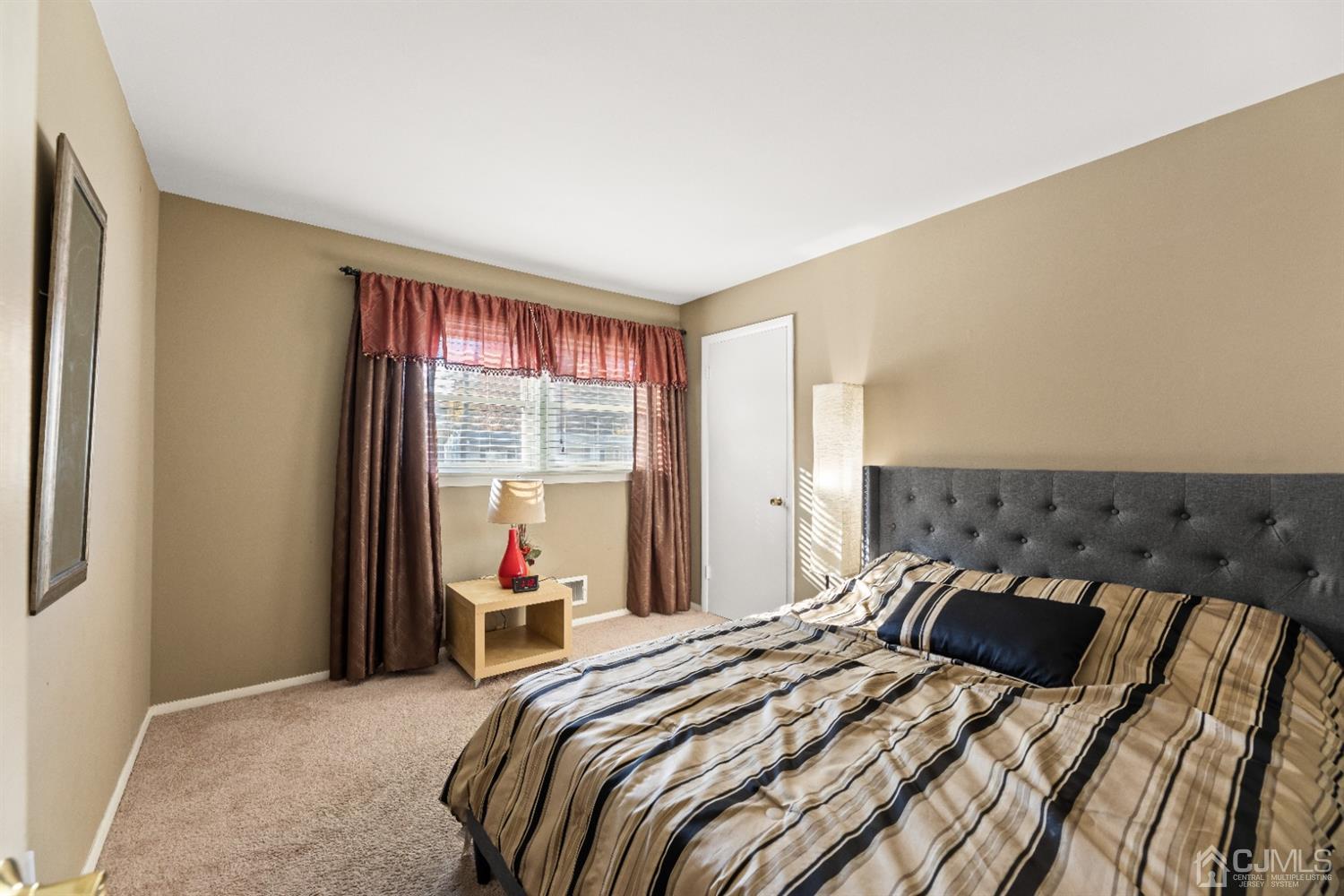 50 Wilk Road Edison, NJ 08837 - Photo 13 of 27 a bedroom with a bed and a large window