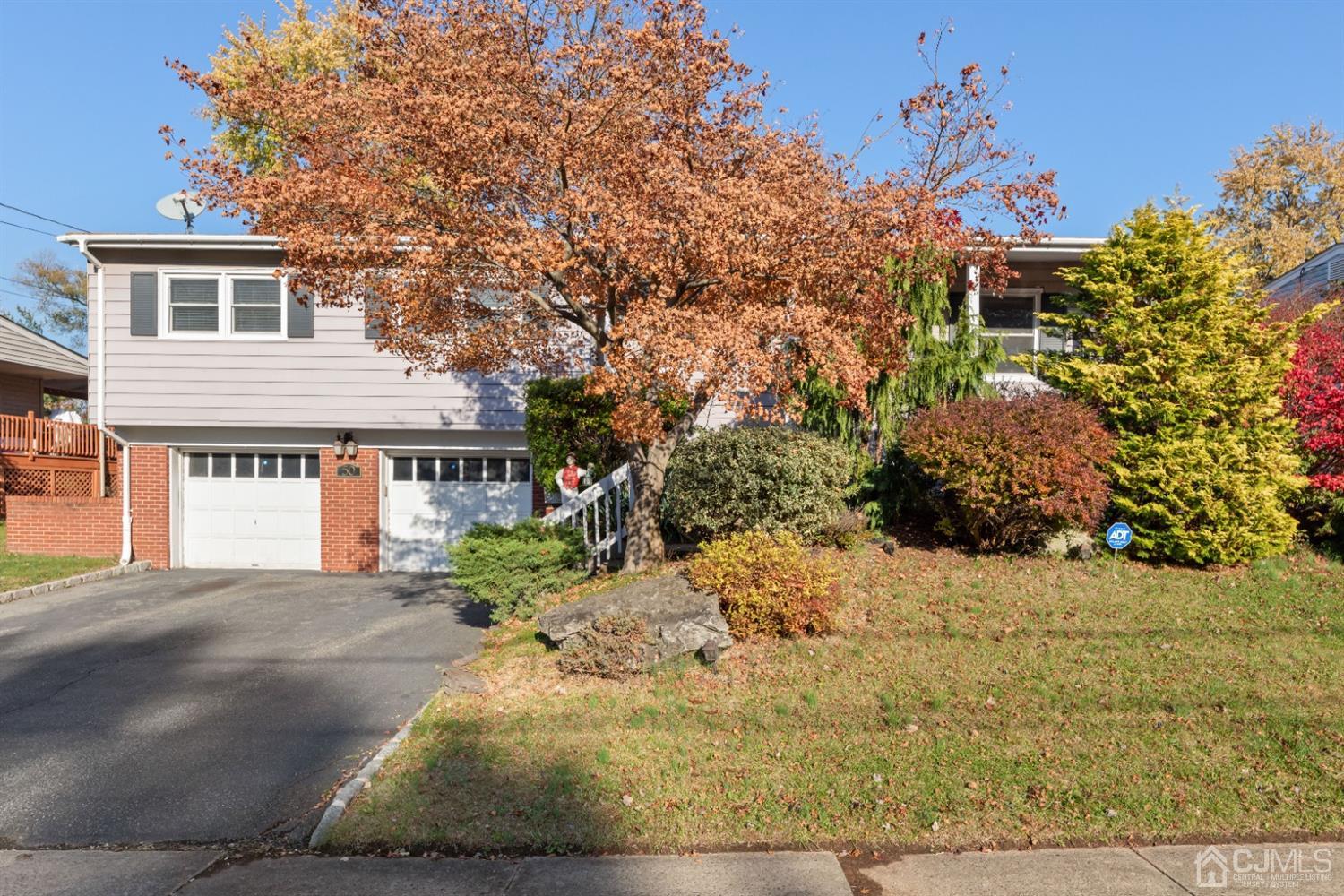 50 Wilk Road Edison, NJ 08837 - Photo 3 of 27 a front view of a house with a yard and garage