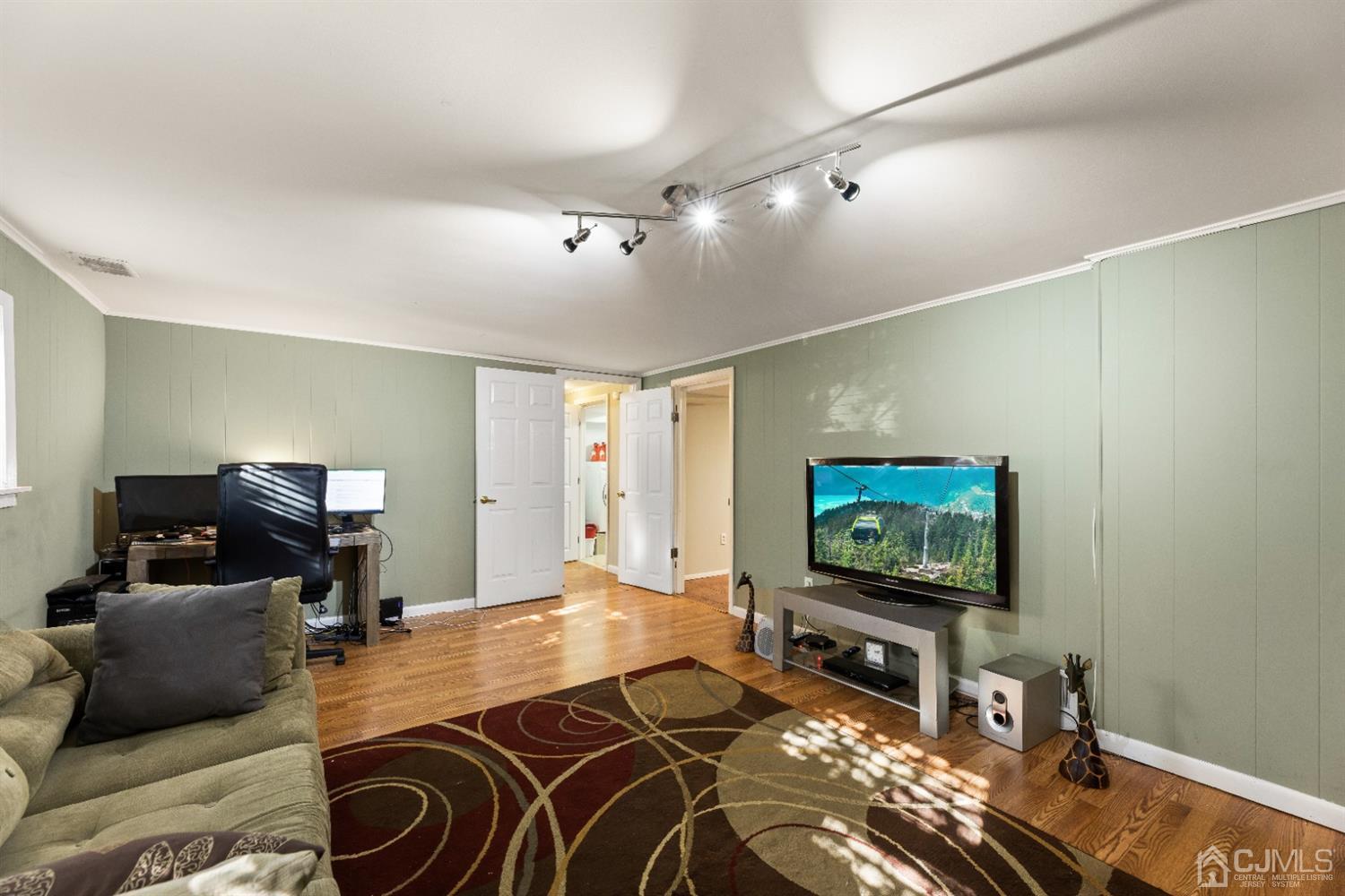 50 Wilk Road Edison, NJ 08837 - Photo 24 of 27 a living room with furniture and a flat screen tv