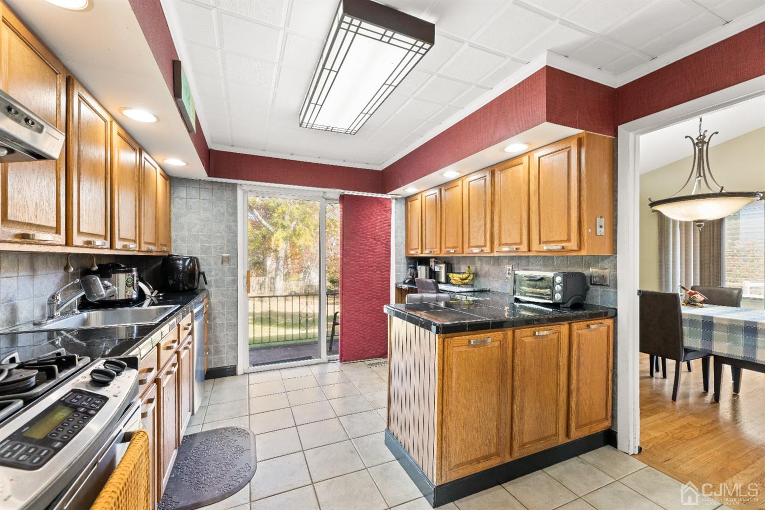 50 Wilk Road Edison, NJ 08837 - Photo 7 of 27 a kitchen with stainless steel appliances granite countertop a stove a sink and a refrigerator