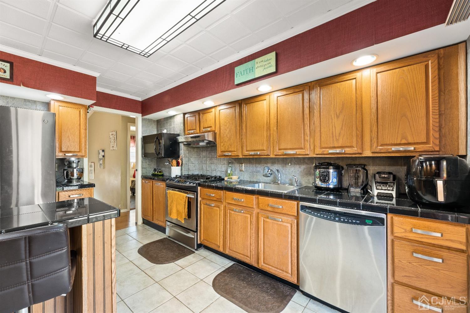 50 Wilk Road Edison, NJ 08837 - Photo 8 of 27 a kitchen with stainless steel appliances a sink window and cabinets