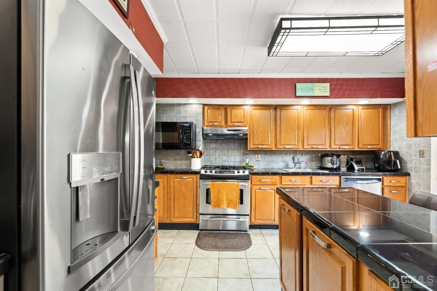 50 Wilk Road Edison, NJ 08837 - Photo 9 of 27 a kitchen with stainless steel appliances granite countertop a sink a stove and a refrigerator