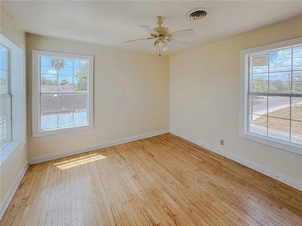 wooden floor in an empty room with a window