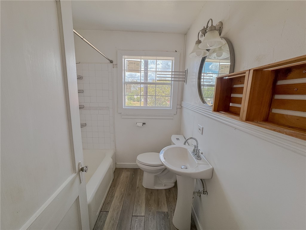 341 Sunset Avenue, Unit B Corpus Christi, TX 78404 - Photo 7 of 8 a bathroom with a sink and a mirror