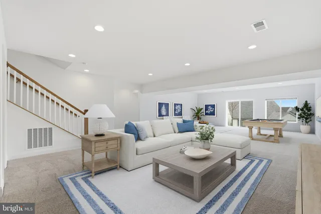 a living room with furniture and a dining table