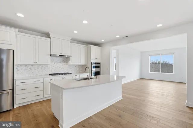 a kitchen with stainless steel appliances granite countertop a stove and a refrigerator