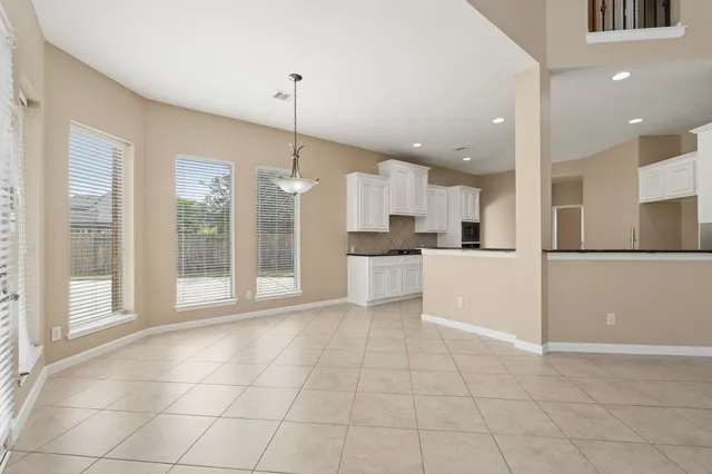 a large kitchen with cabinets and stainless steel appliances
