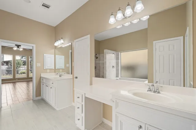a bathroom with a double vanity sink and a mirror
