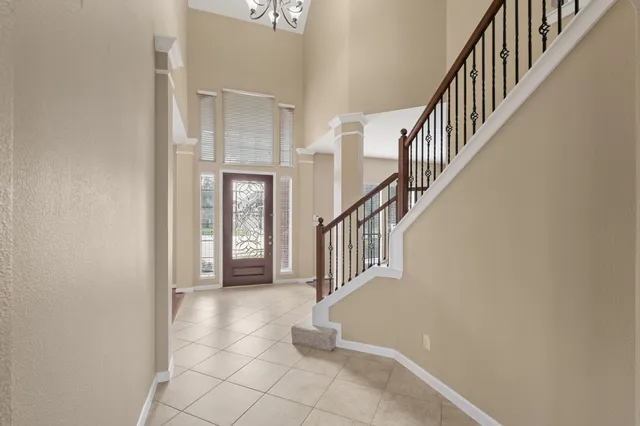 a view of entryway and hall with a front door