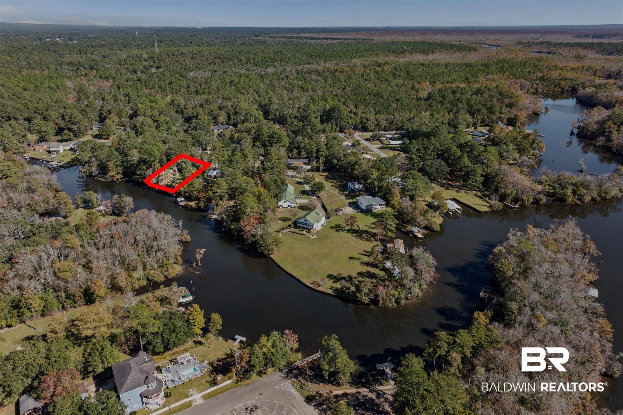 431 Simms Drive Saraland, AL 36571 - Photo 26 of 34 Aerial view of property and surrounding area featuring a heavily wooded area and a large body of water