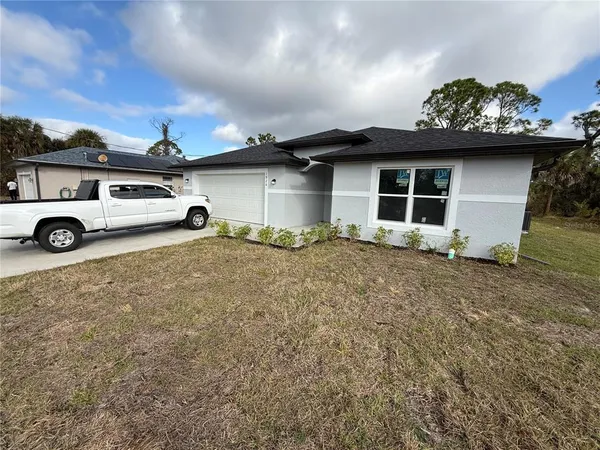 a view of garage with a car parked in it