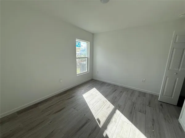 a view of wooden floor and windows in a room