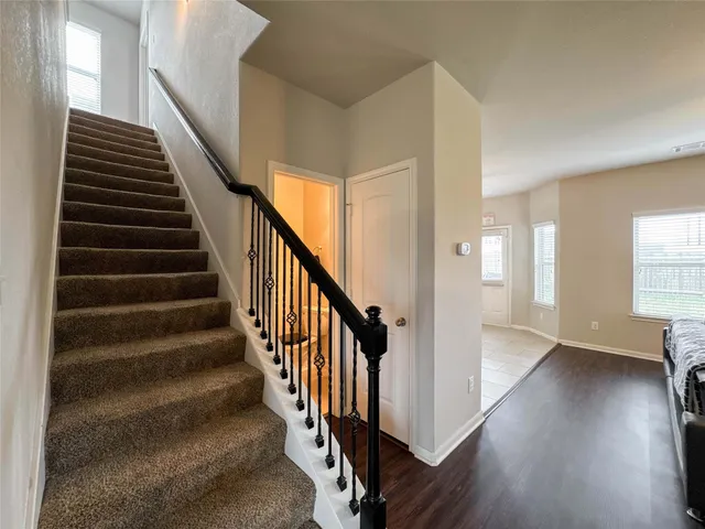 a view of an entryway with wooden floor and stairs