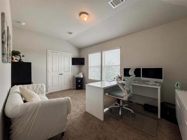 a workspace with furniture and a large window