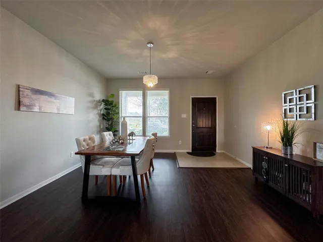 a view of a dining room with furniture and window
