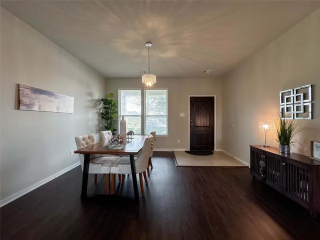 a view of a dining room with furniture and window