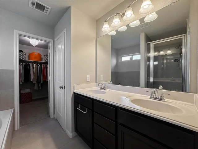 a bathroom with a sink double vanity and a mirror