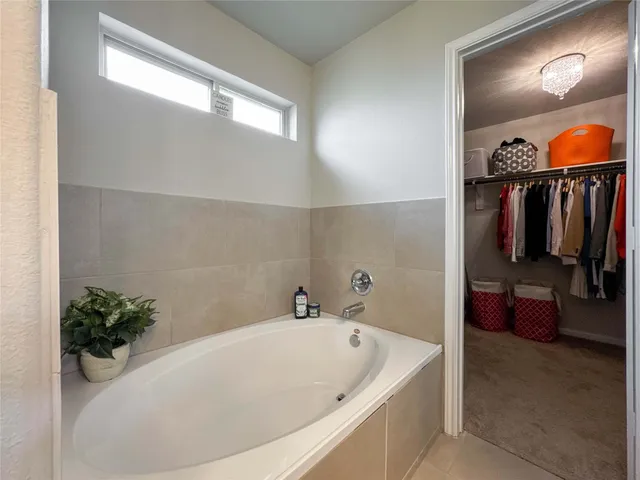 a bathroom with a tub and shower