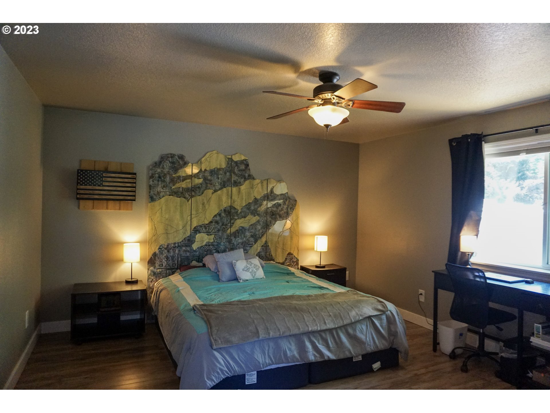 828 South 73rd Street Springfield, OR 97478 - Photo 13 of 23 a bedroom with a bed and a chandelier